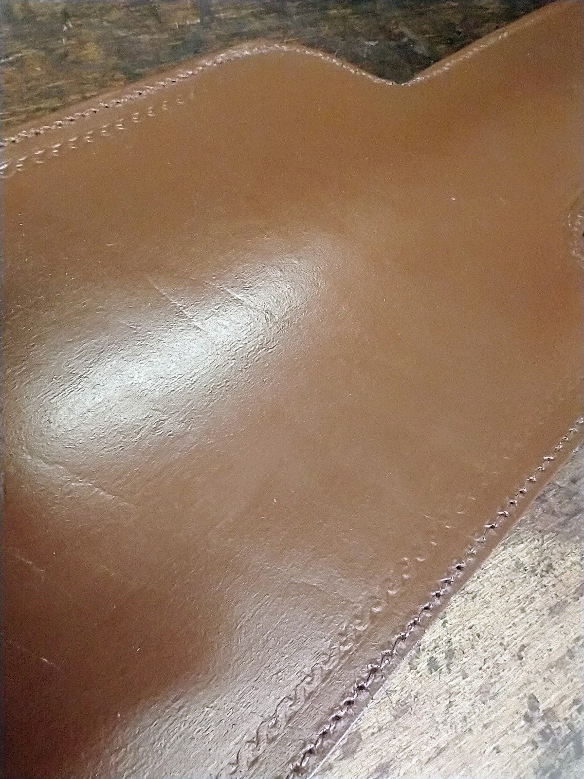An old leather cartridge bag with a badly damaged flap and extremely dry leather
